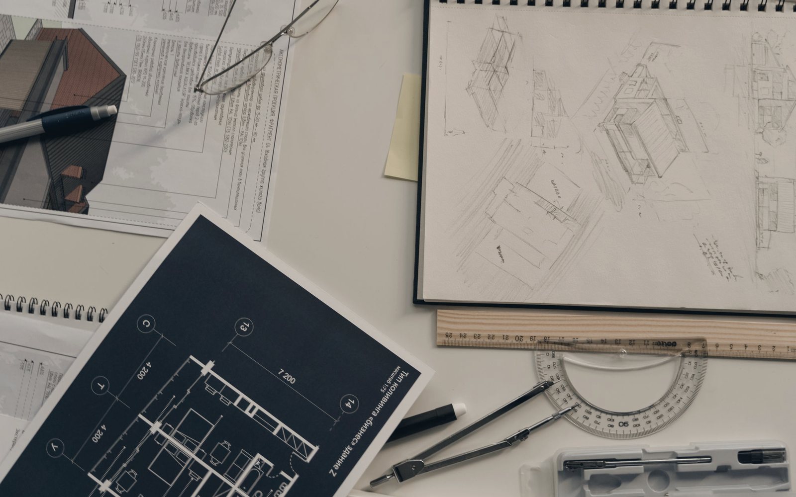 Temporary photograph of architectural sketches, blueprints and drawing tools on a desk
