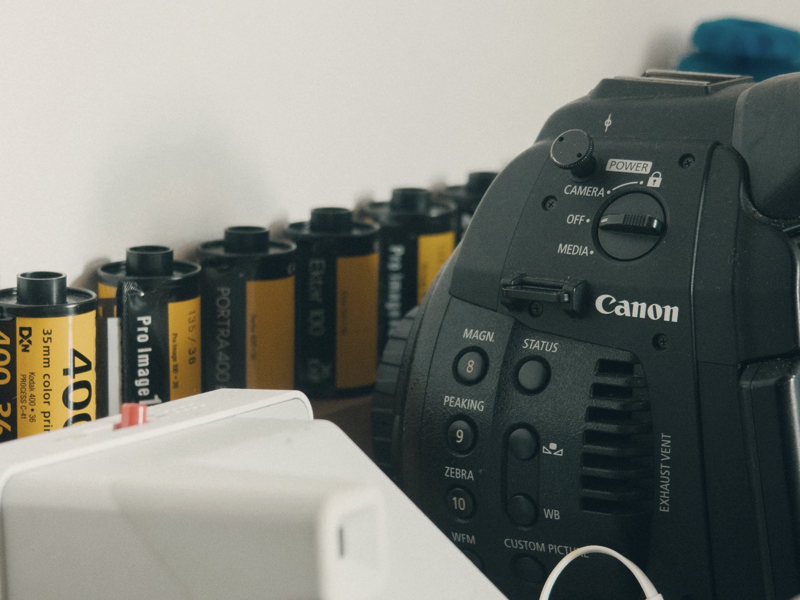Temporary photograph of a camera and film rolls in a studio