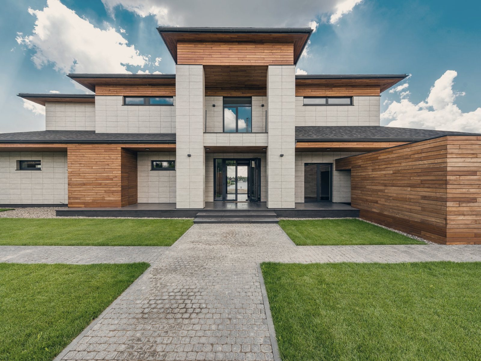 Temporary photograph of a contemporary courtyard house with stone paving and planting